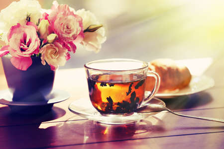 Cup of tea with croissants on tableの写真素材