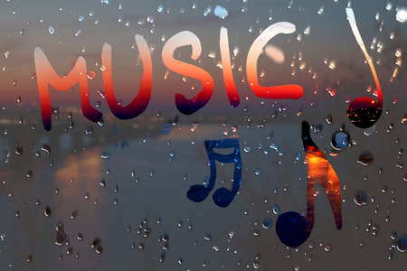 Water drops on glass with text music.の写真素材
