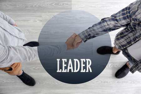 Business training concept. Men shaking hands in room, top viewの写真素材