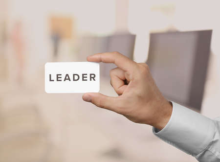 Business trainer with business card, close-upの写真素材