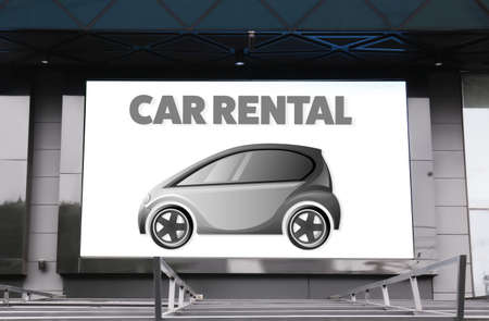 Digital advertisement display with text car rental on building.の写真素材