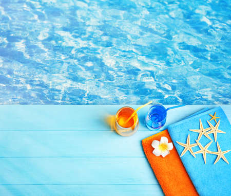 Summer beach set on swimming pool water backgroundの写真素材