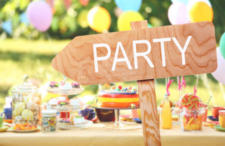 Word PARTY on wooden signboard against blurred festive backgroundの写真素材