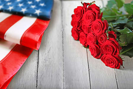 Roses and USA flag on wooden background. Symbol of Americaの写真素材