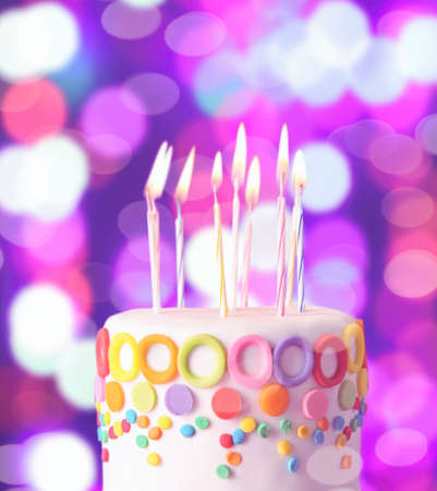 Birthday cake with candles on colorful backgroundの写真素材