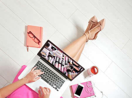 Woman watching online tutorial on laptop. Makeup and beauty blog.の写真素材