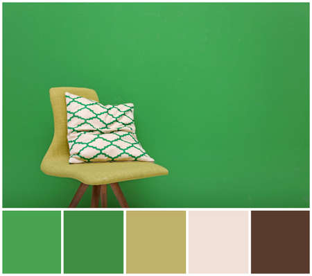 Cozy chair with pillow on wall background. Palette with green colorの写真素材