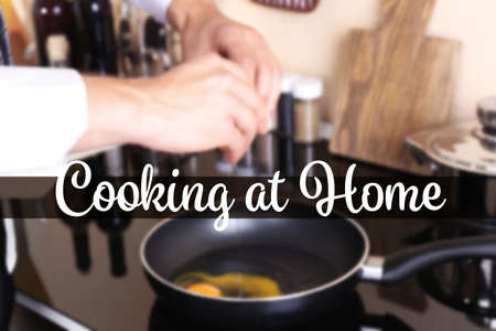 Cooking at home concept. Man preparing breakfast at kitchenの写真素材