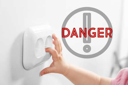 Baby playing with power socket, closeupの写真素材