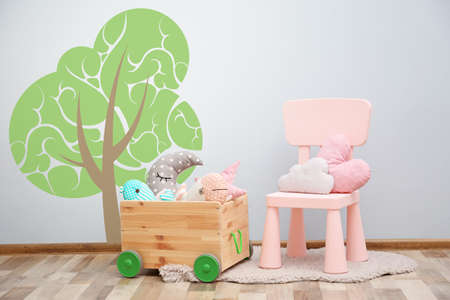 Chair with toys near wall in children roomの写真素材
