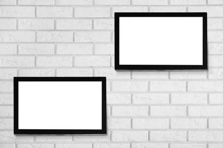 Modern TV screens on brick wall backgroundの写真素材