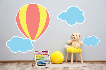 Stool with toys near wall in children roomの写真素材