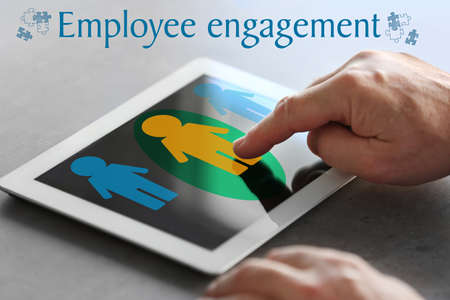 Man working with tablet at table. Concept of employee engagementの写真素材