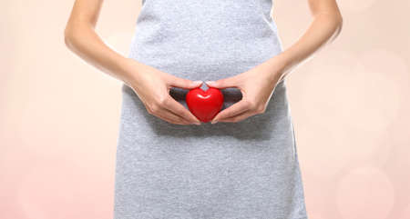 Gynecology concept. Young woman on color backgroundの写真素材