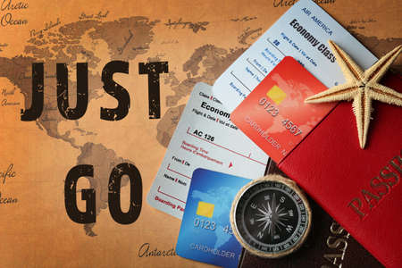 Text JUST GO, credit cards with passports and tickets on map backgroundの写真素材