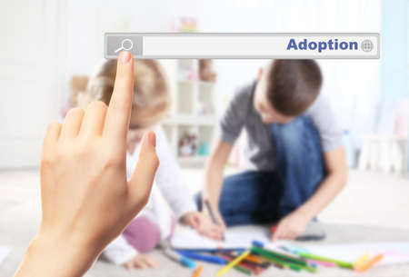 Adoption concept. Female hand pushing on search box の写真素材
