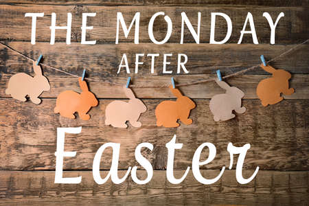 Text THE MONDAY AFTER EASTER and garland on wooden backgroundの写真素材
