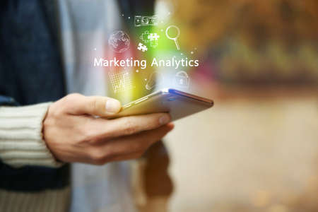 Marketing analytics concept. Man using smartphone outdoorsの写真素材
