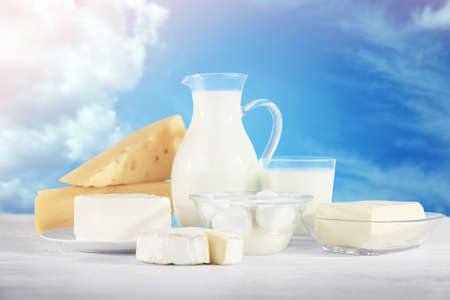 Assortment of fresh dairy products on sky backgroundの写真素材