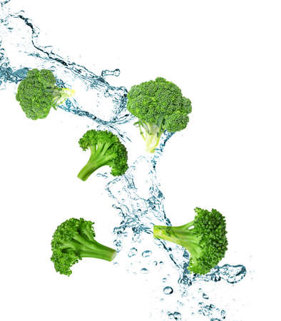 Splashing water and broccoli on white backgroundの写真素材