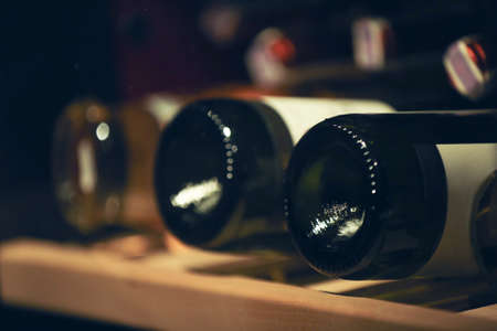 Bottles of wine on shelf at store, closeupの写真素材