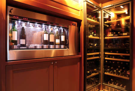 Dispenser and refrigerators with bottles of wine in cellarの写真素材