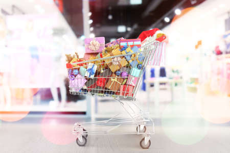 Market trolley with gifts at shopping mall. Boxing day conceptの写真素材