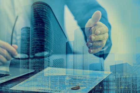 Concept of consulting. Double exposure of cityscape and hr manager with resumeの写真素材