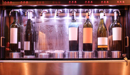 Dispenser with opened bottles of wine in cellar, closeupの写真素材