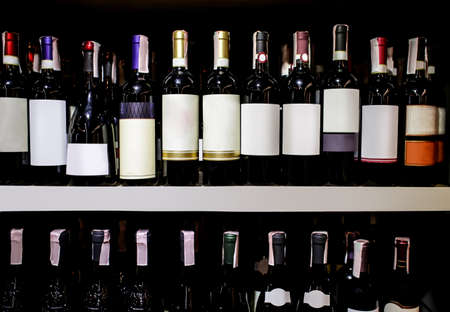 Rack with bottles of wine at storeの写真素材