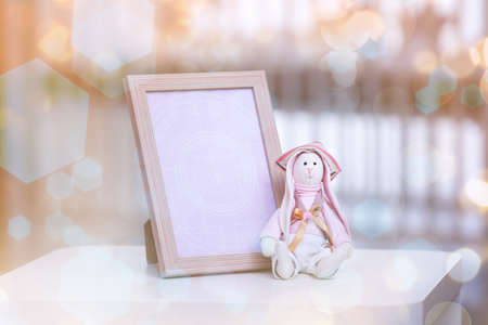 Photo frame and toy for baby on Christmas lights background. Holidays celebration conceptの写真素材