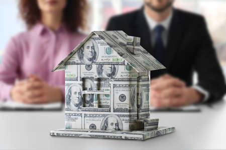 Money house and real estate agents on backgroundの写真素材