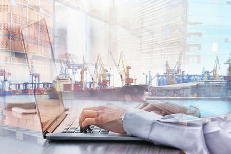 Double exposure of seaport and businessman with laptop. Wholesale and logistic conceptの写真素材