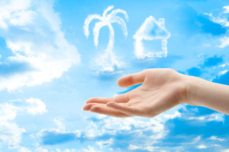 Female hands and clouds of different shapes on sky backgroundの写真素材