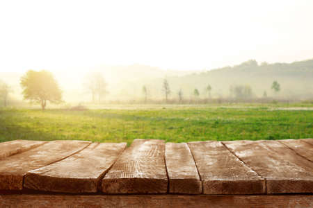 Empty wooden table and beautiful landscape on backgroundの写真素材