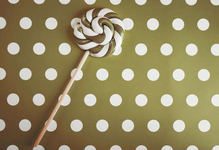 Sweet lollipop on patterned backgroundの写真素材
