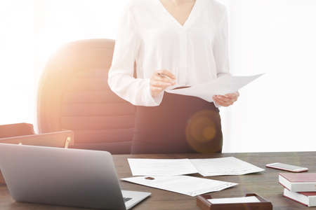 Successful businesswoman working with documents in officeの写真素材