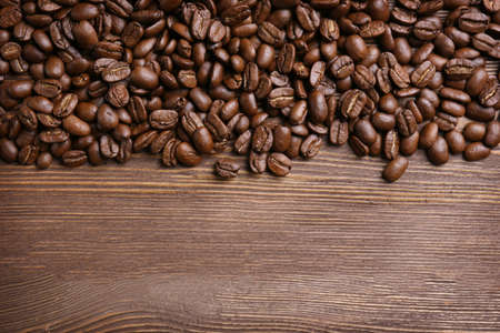 Coffee beans on wooden backgroundの写真素材