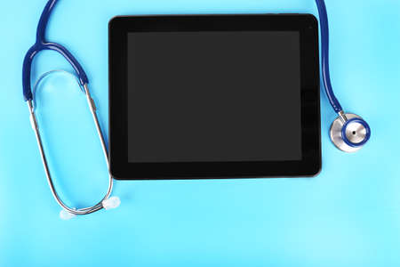 Tablet and stethoscope on blue backgroundの写真素材