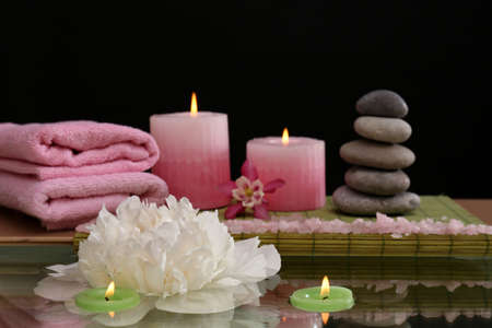 Spa still life with flower and candlelight on black backgroundの写真素材