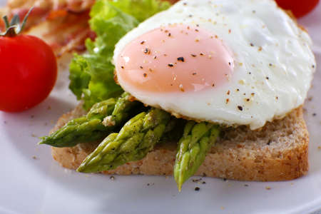 Dish of asparagus and egg in plate on table, closeupの写真素材