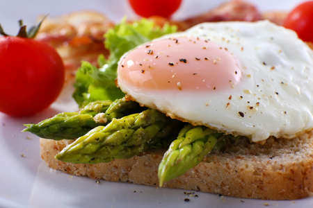 Dish of asparagus and egg in plate on table, closeupの写真素材