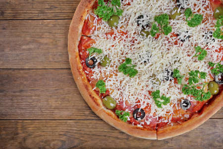 Pizza with cheese on wooden table backgroundの写真素材