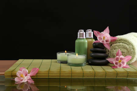 Spa still life with flowers and candlelight on black backgroundの写真素材
