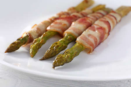 Dish of asparagus and bacon in plate, closeupの写真素材