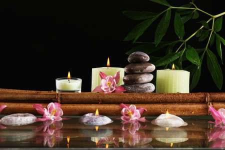 Spa still life with flowers and candlelight on black backgroundの写真素材