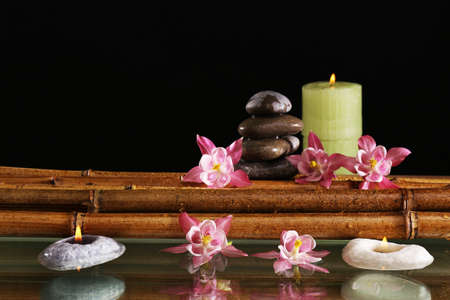 Spa still life with flowers and candlelight on black backgroundの写真素材