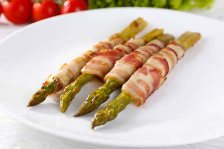 Dish of asparagus and bacon in plate, closeupの写真素材
