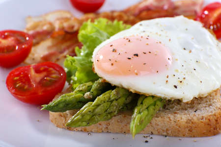 Dish of asparagus and egg in plate on table, closeupの写真素材