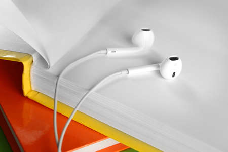 Earphones and books on table, closeupの写真素材